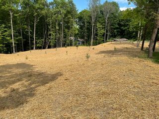 A bulldozer is working on a dirt field.