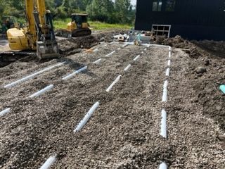 A large pile of dirt is sitting in front of a house.