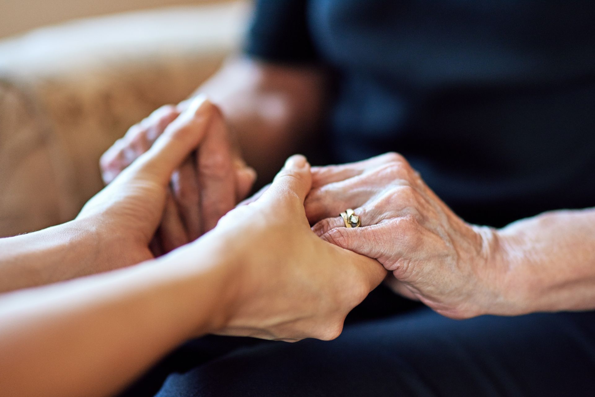 two people holding hands in grief