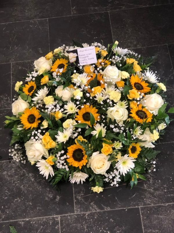 white and yellow funeral flower Arrangement