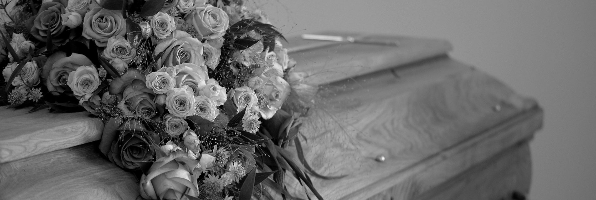 flower arrangement on top of coffin