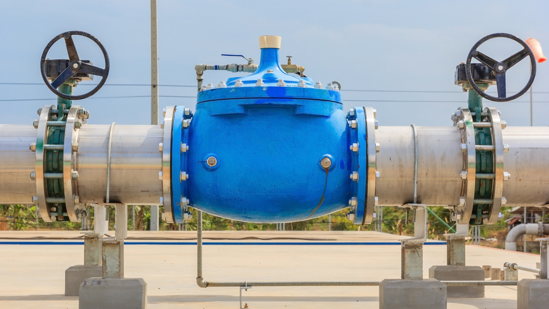 A bunch of metal pipes are stacked on top of each other.