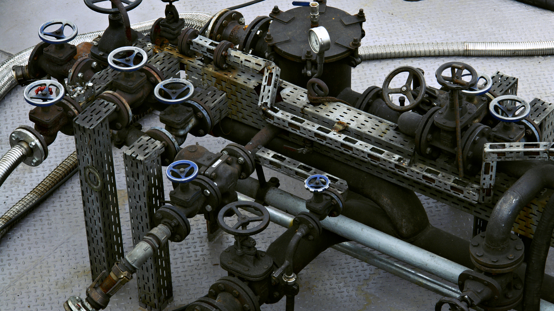 A warehouse filled with lots of metal pipes stacked on top of each other.