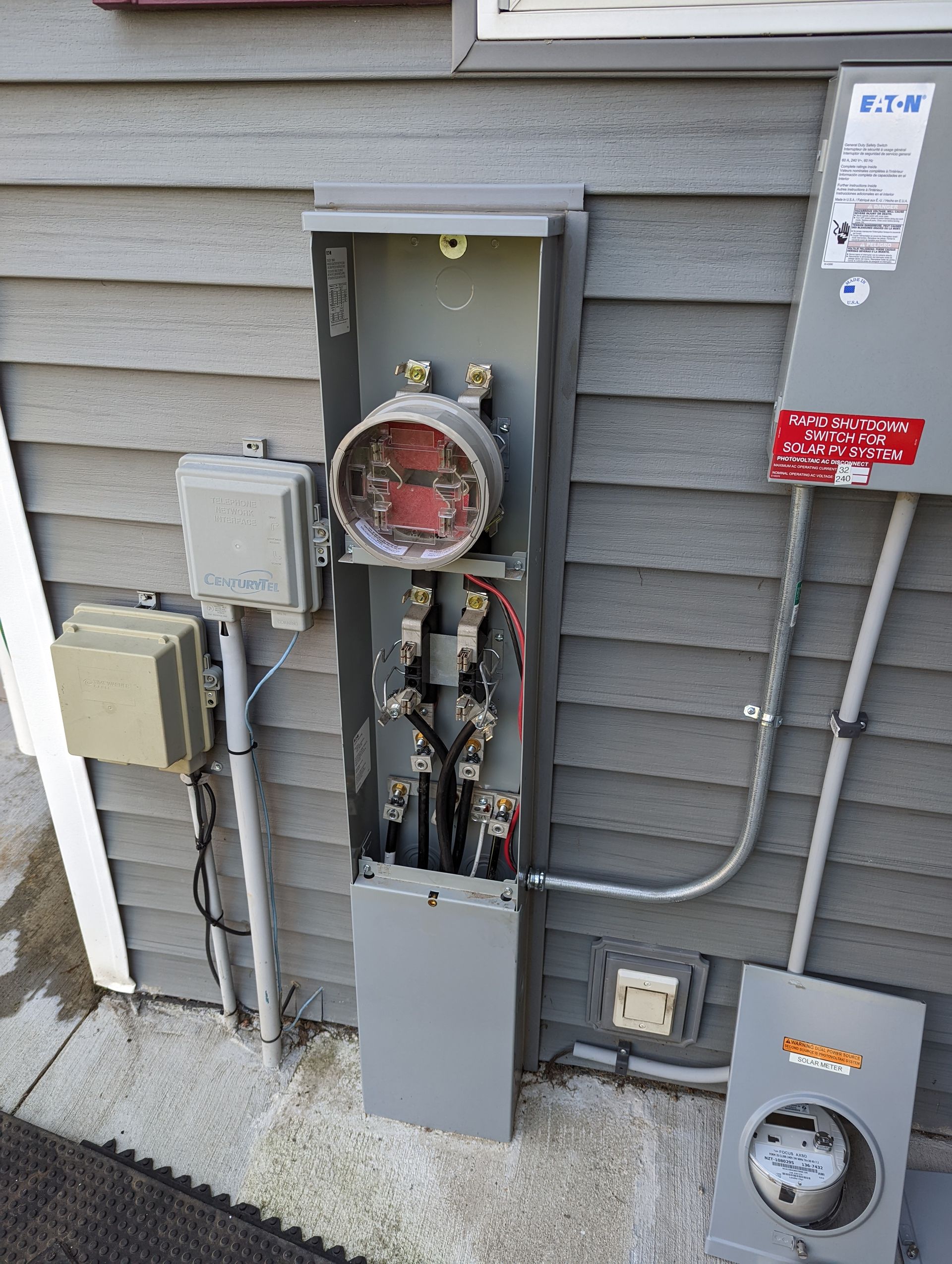 There is a meter on the side of a building.