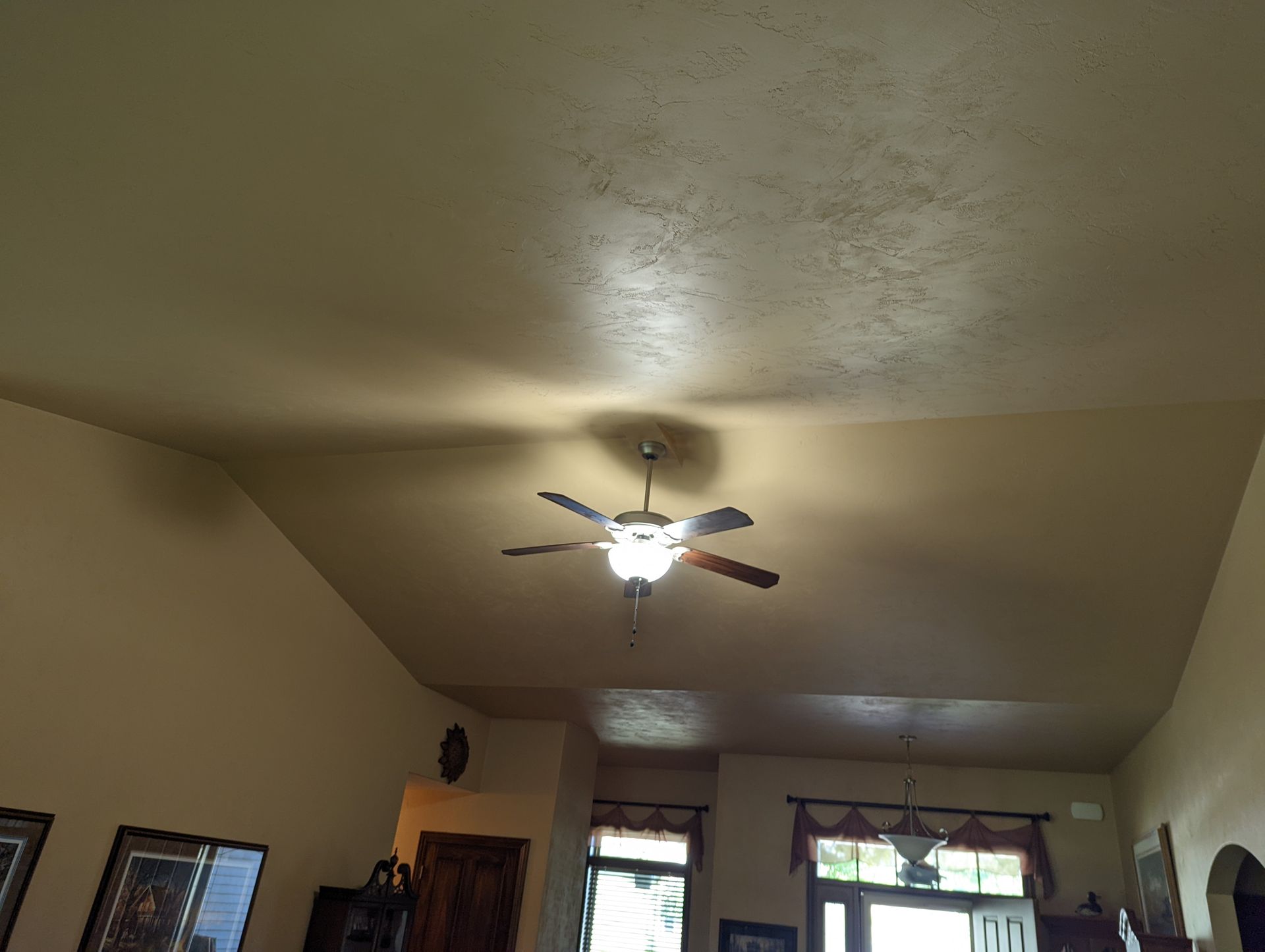 A ceiling fan is hanging from the ceiling of a living room