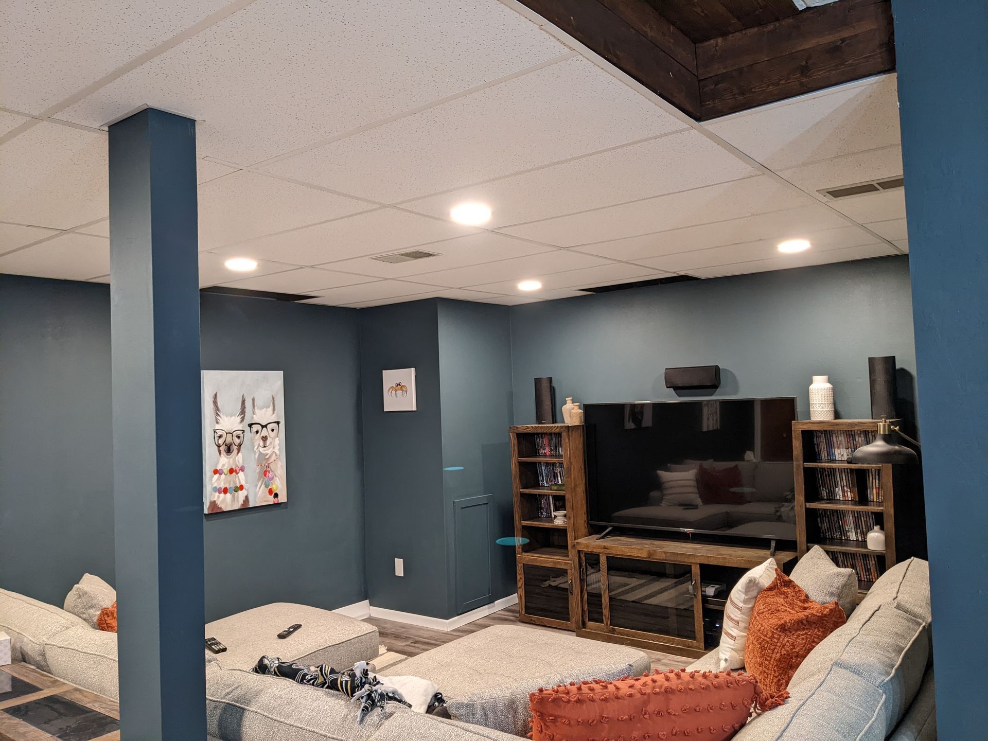 A living room with blue walls and a flat screen tv.