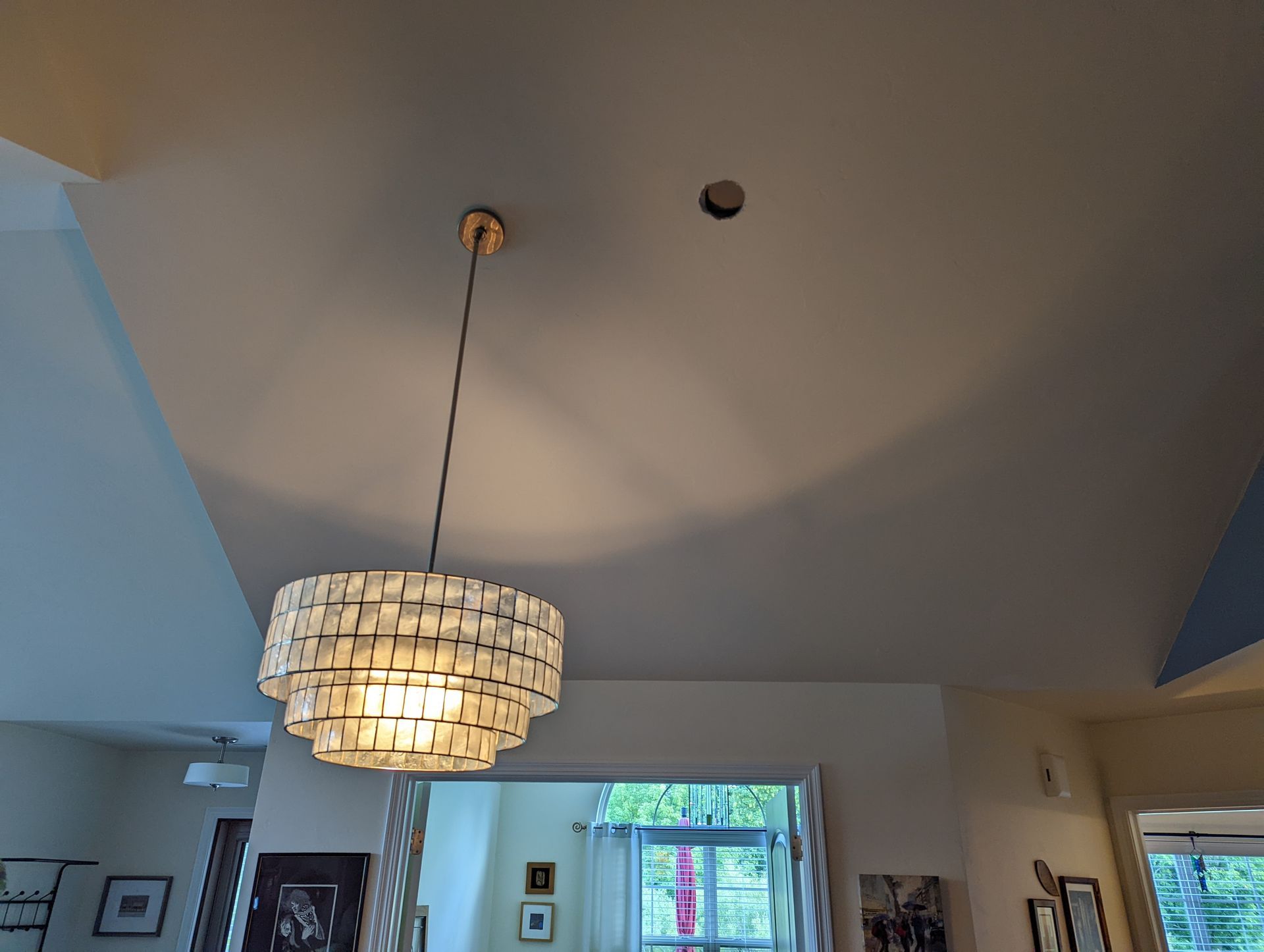 A chandelier is hanging from the ceiling in a living room.