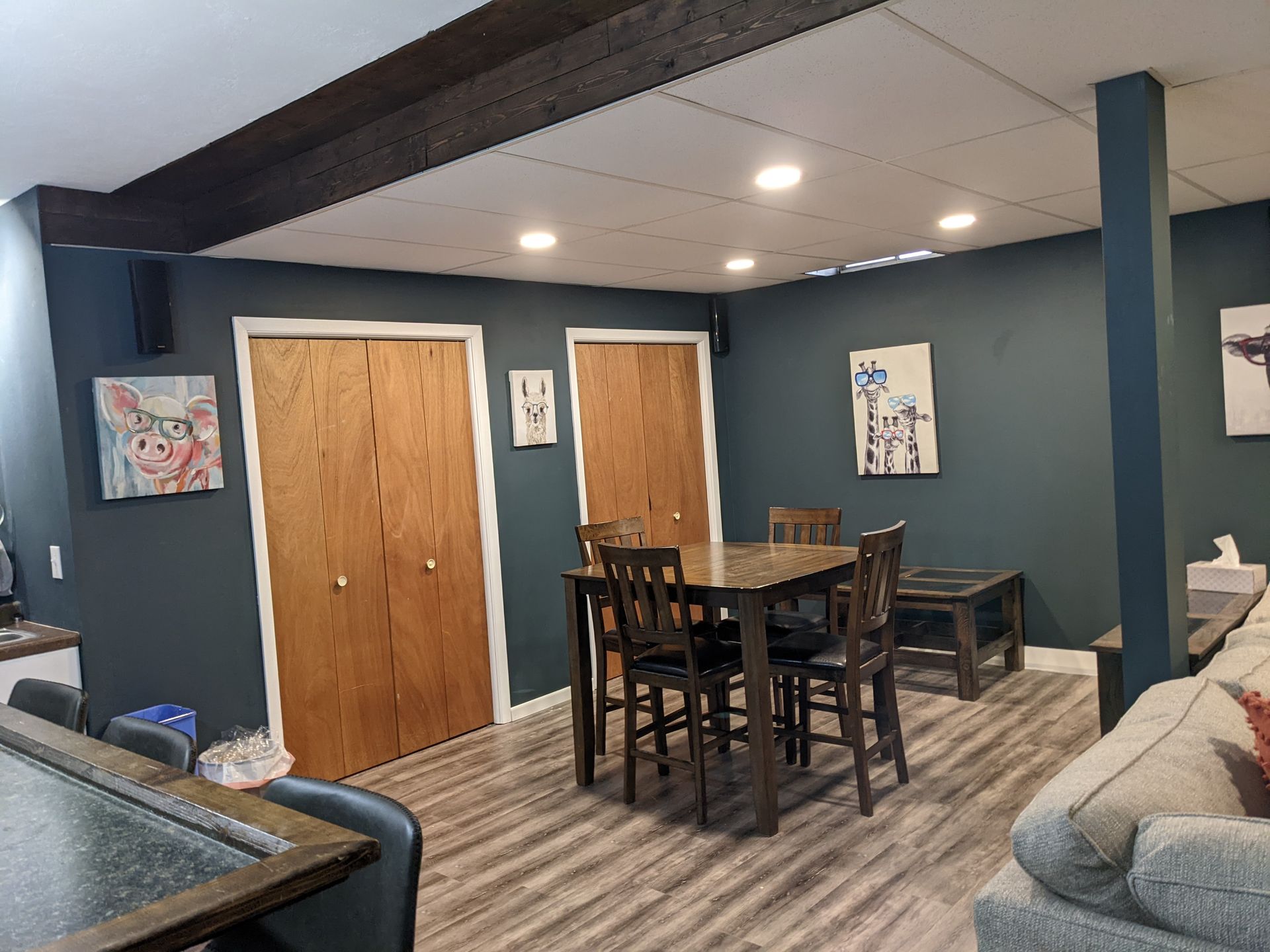 A living room with a table and chairs and a couch.
