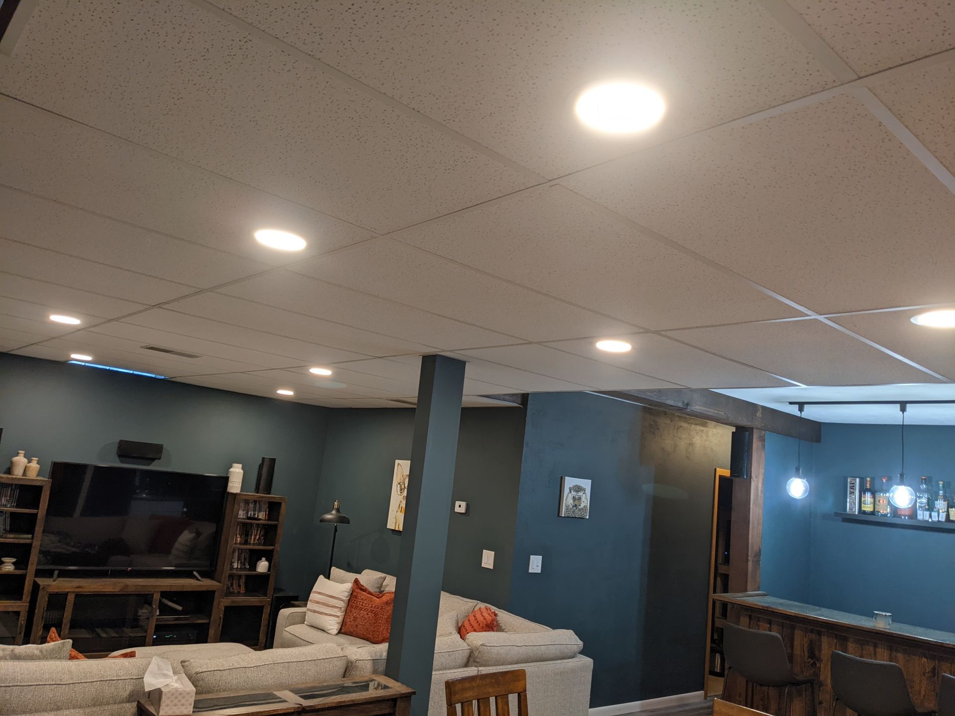 A living room with a couch , table , chairs and a television.