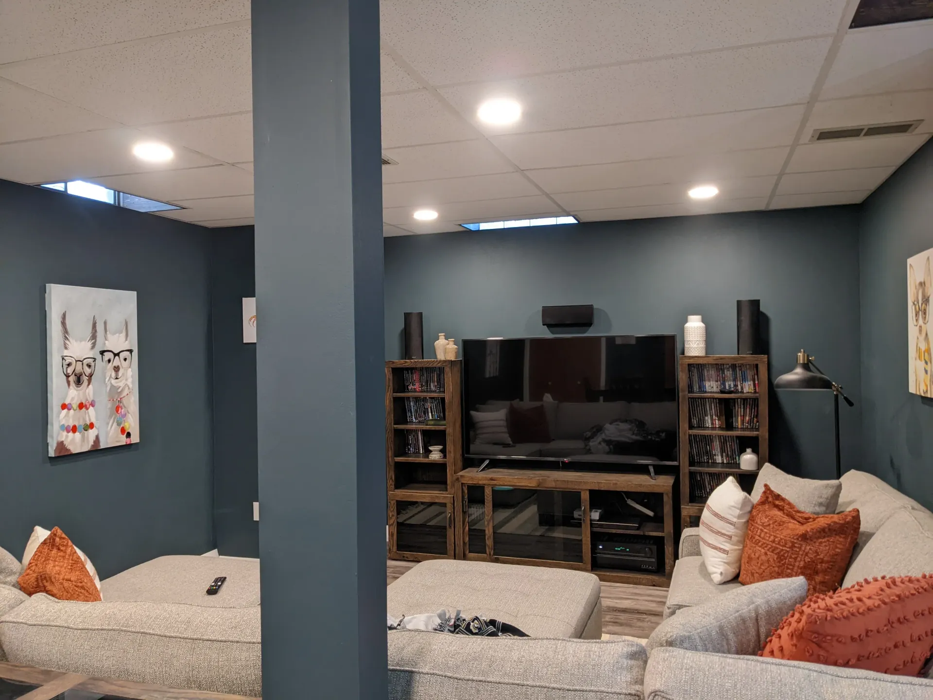 A living room with a couch , chair , and television.