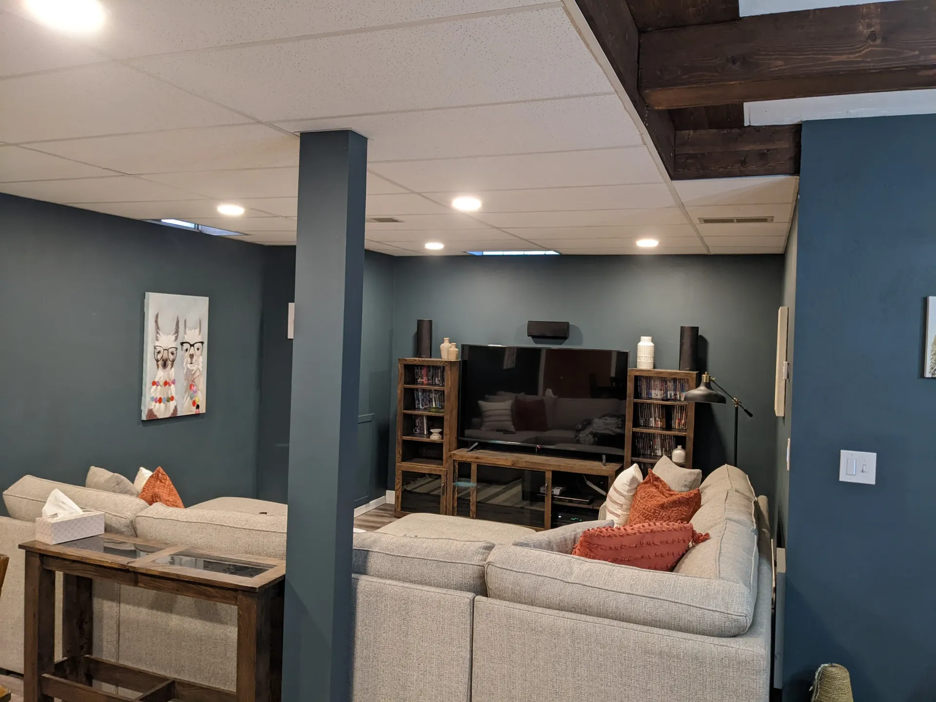 A living room with a couch , television , and entertainment center.