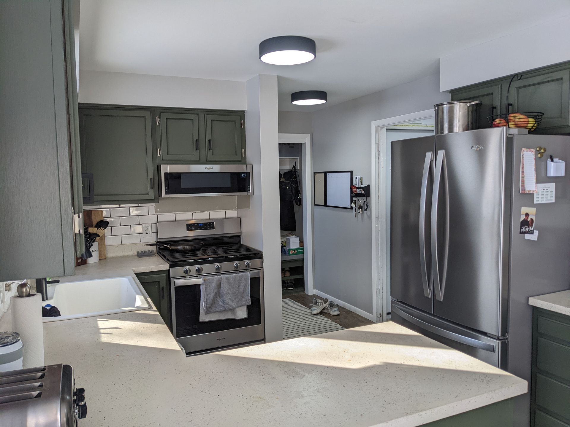 A kitchen with a stove , refrigerator , and microwave.