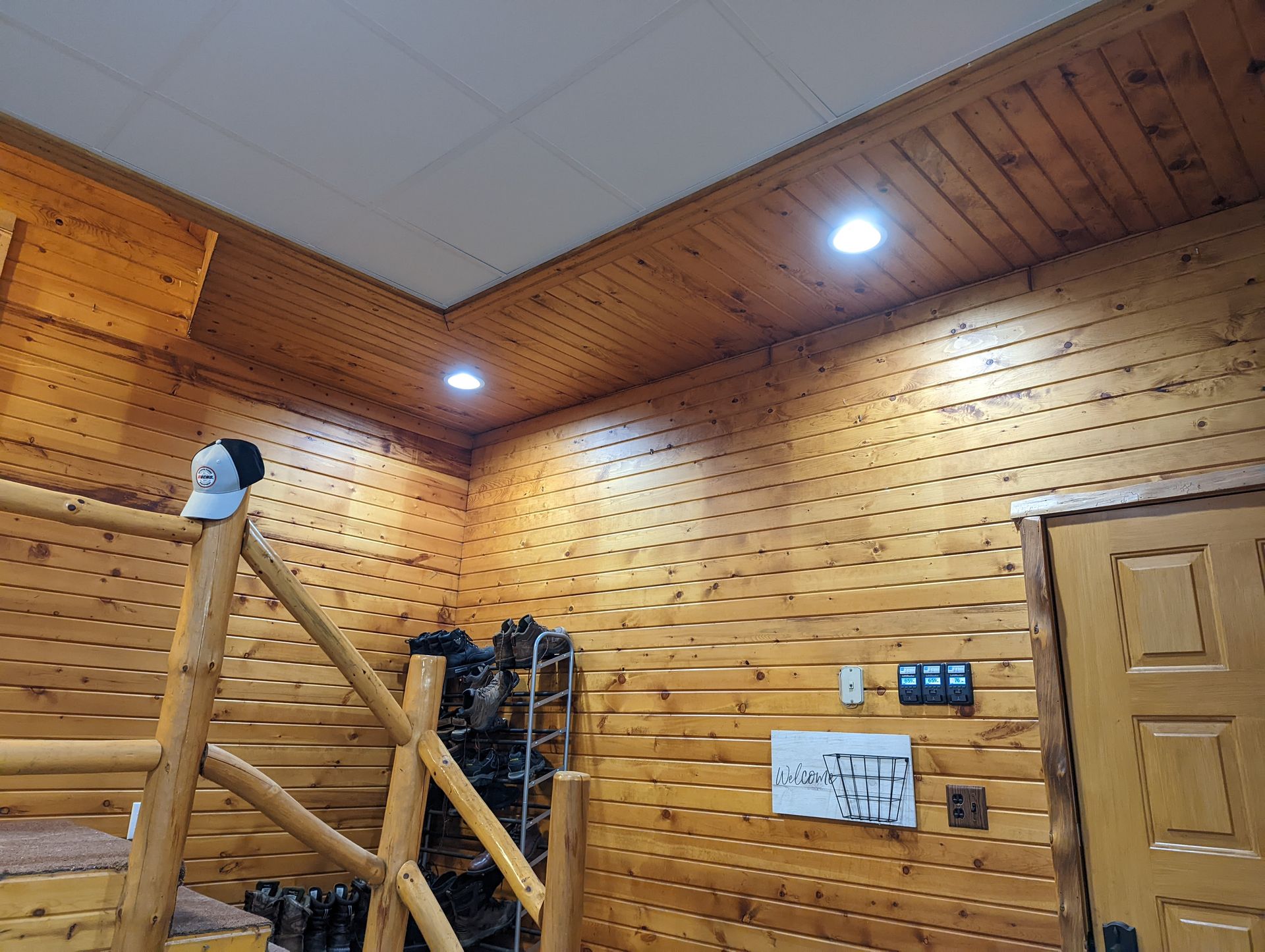 A log cabin with a staircase leading up to the second floor.