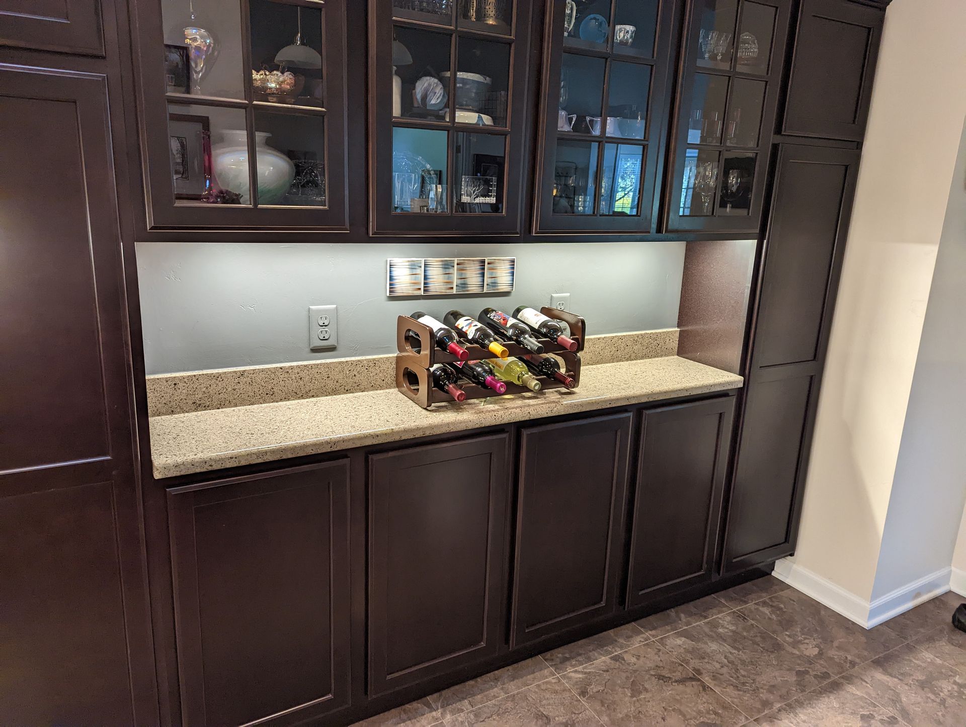 A wine rack is sitting on a counter in a kitchen.