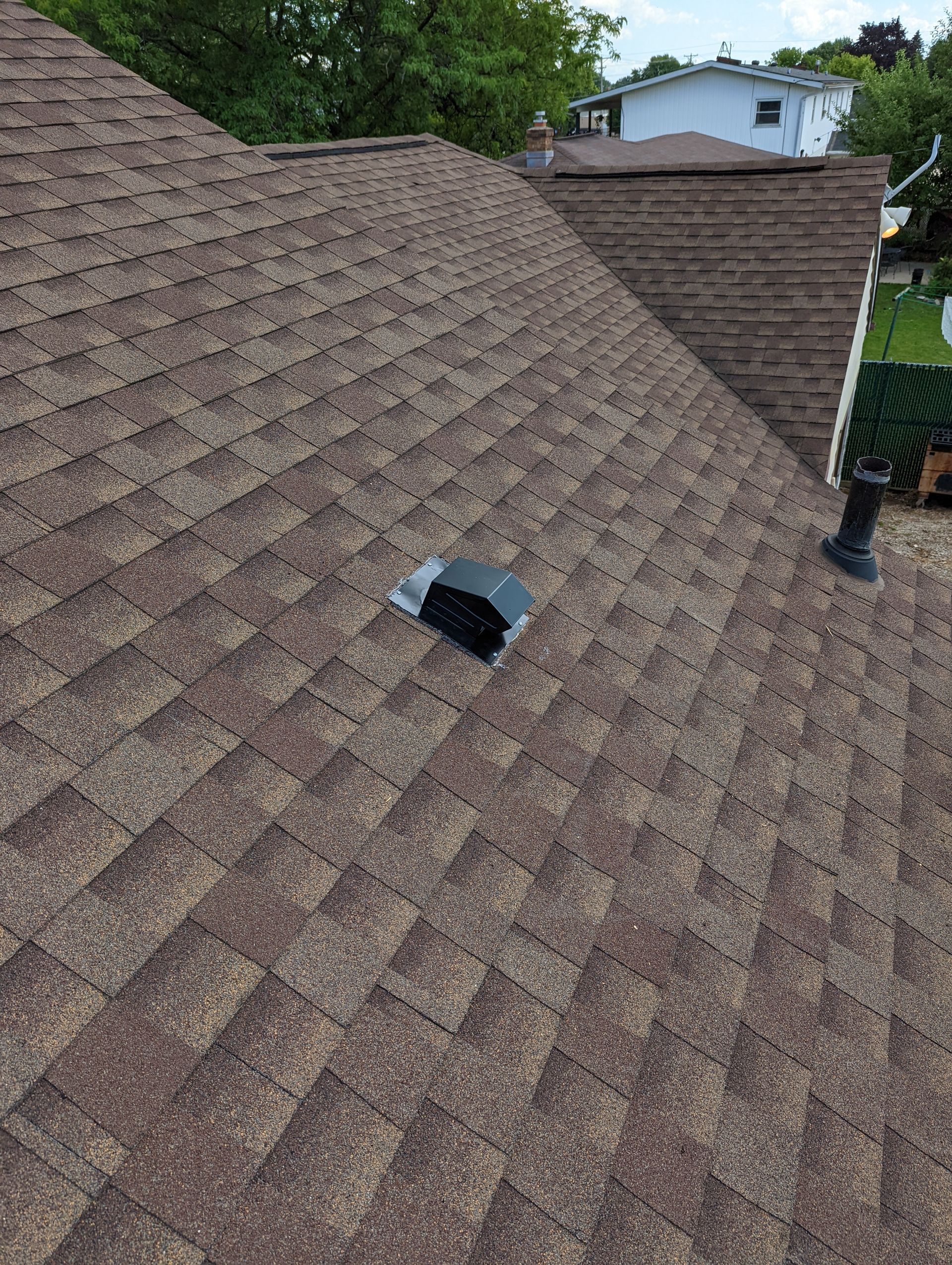 A roof with a hole in it and a chimney on it.