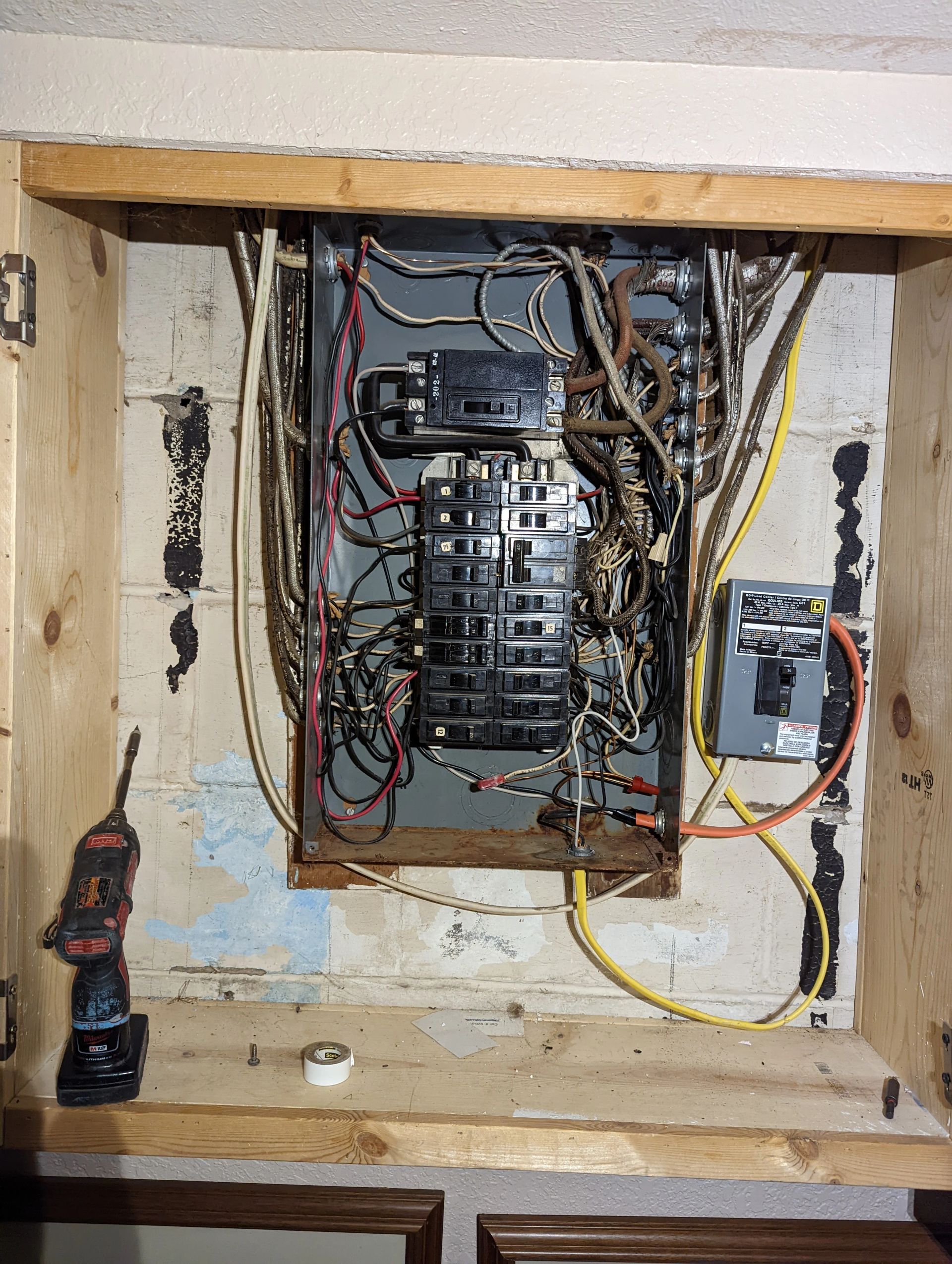 A very old electrical box with a lot of wires coming out of it.