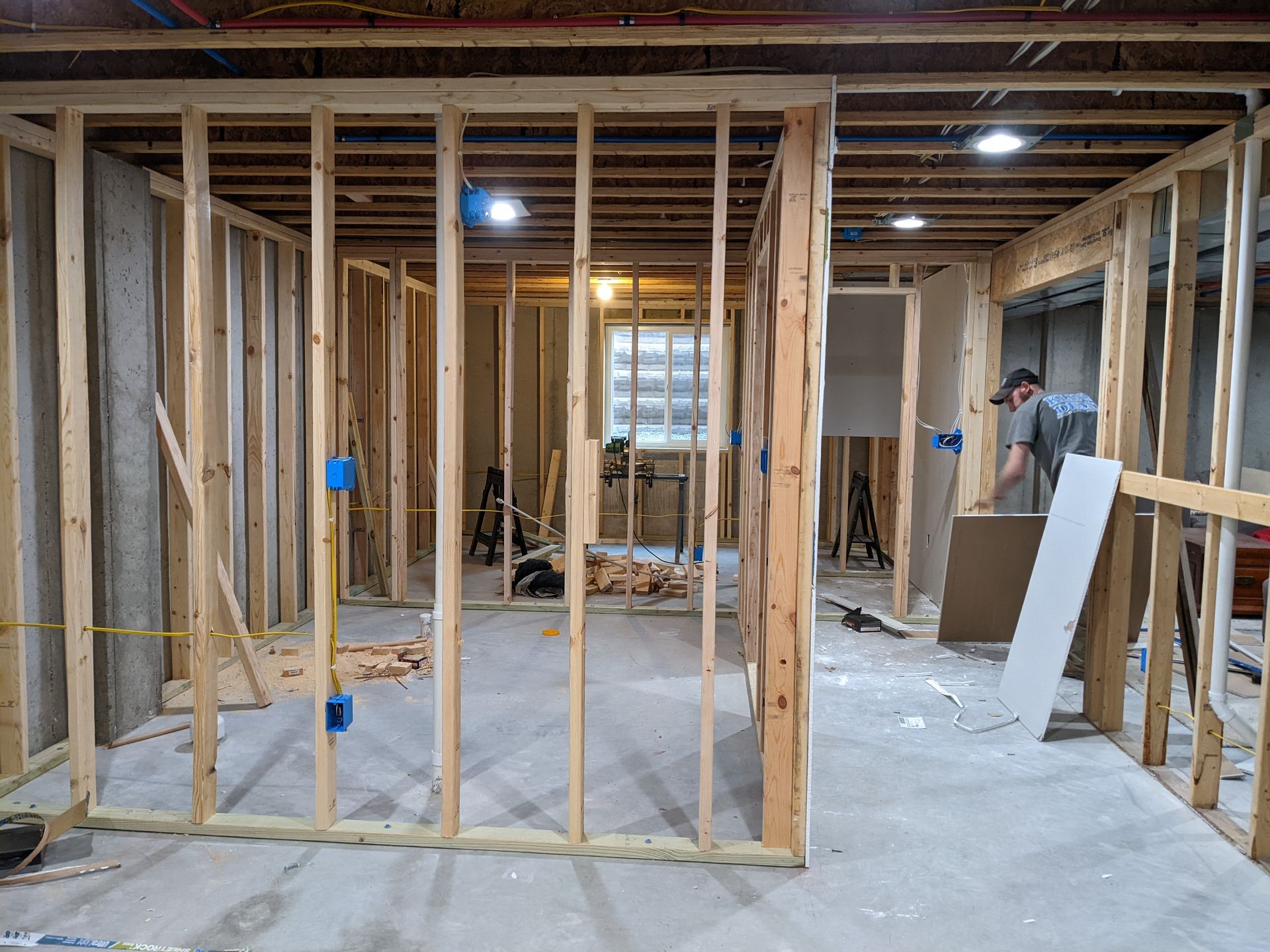 A man is working in a basement under construction.
