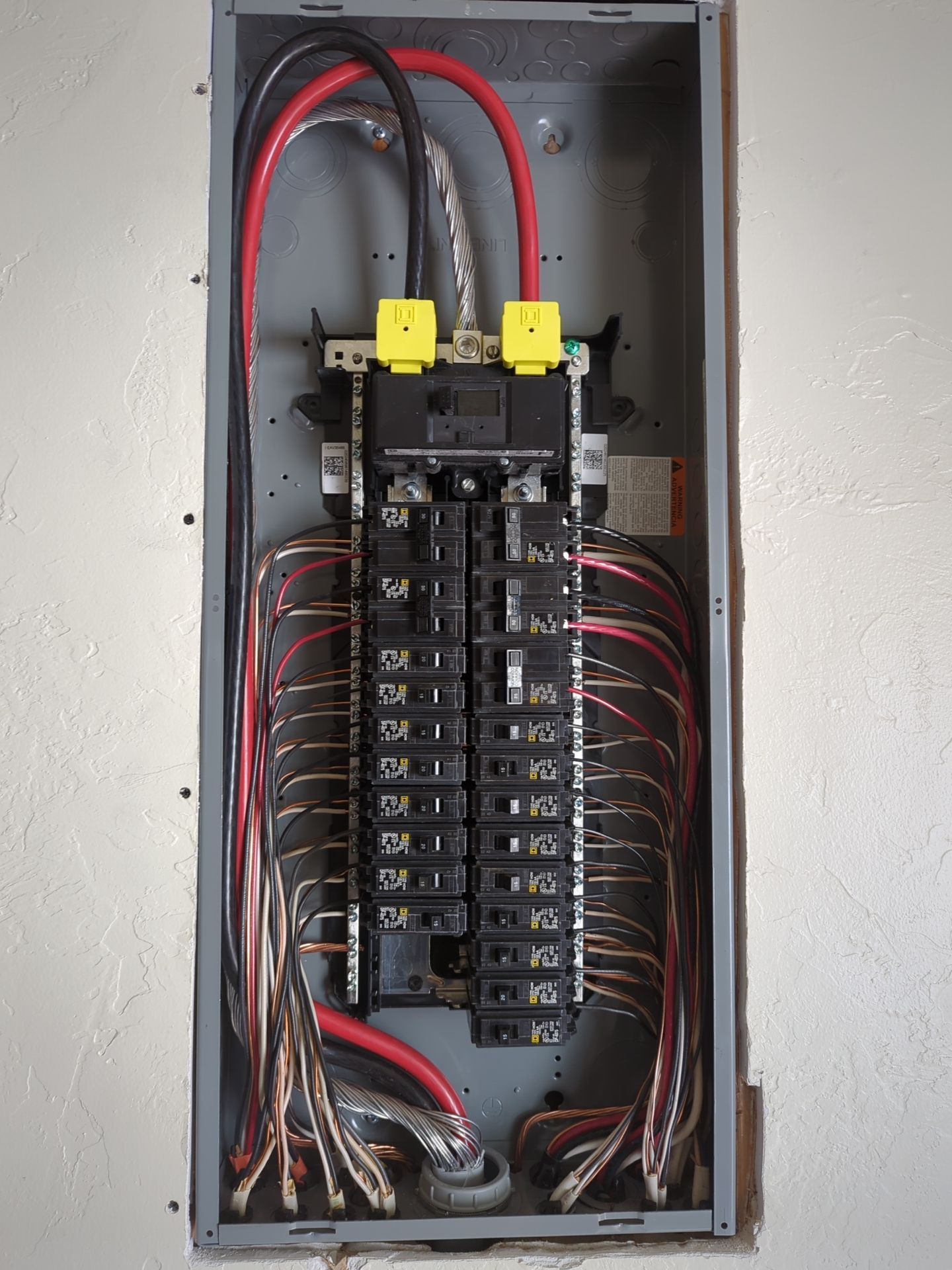 A close up of a electrical box with wires coming out of it
