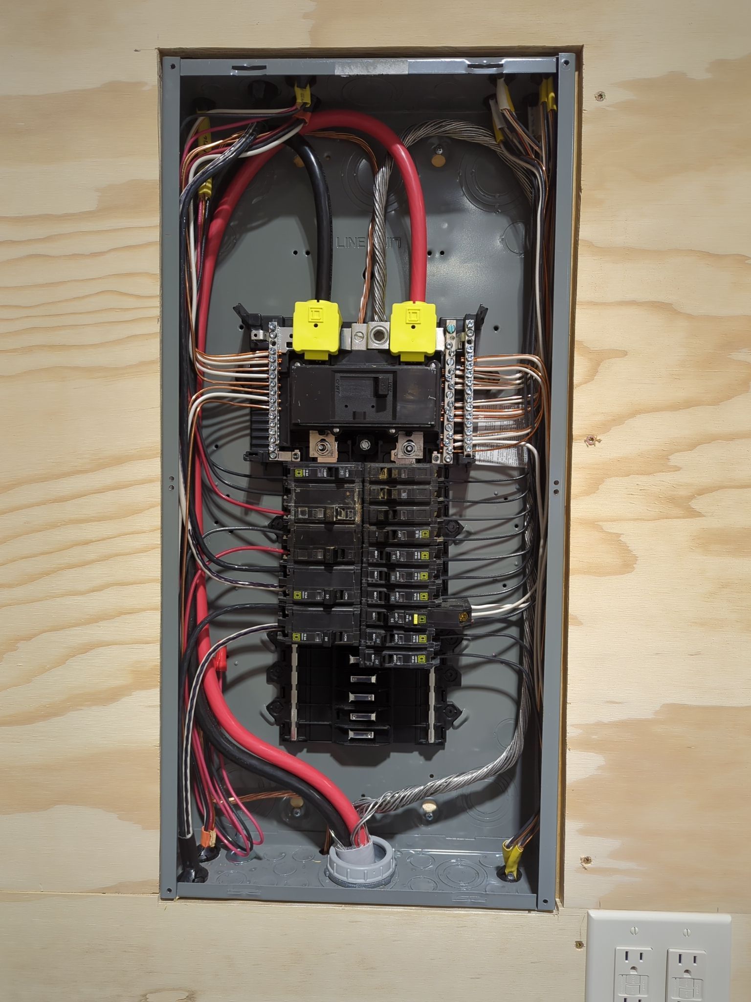 The inside of an electrical box with red wires coming out of it
