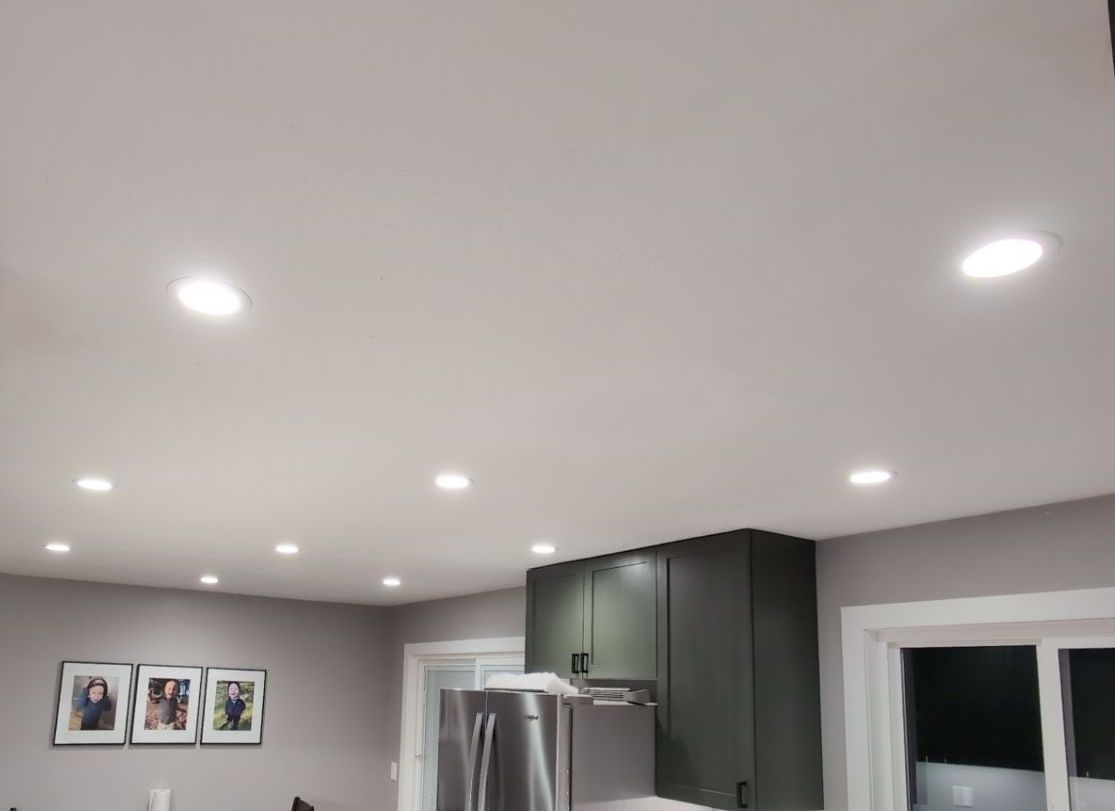 A kitchen with a ceiling that has a lot of lights on it.