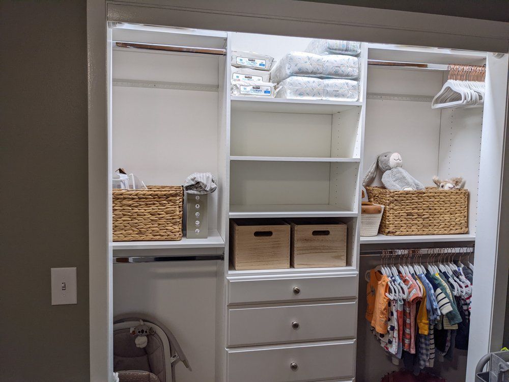 A closet filled with lots of clothes and baskets.