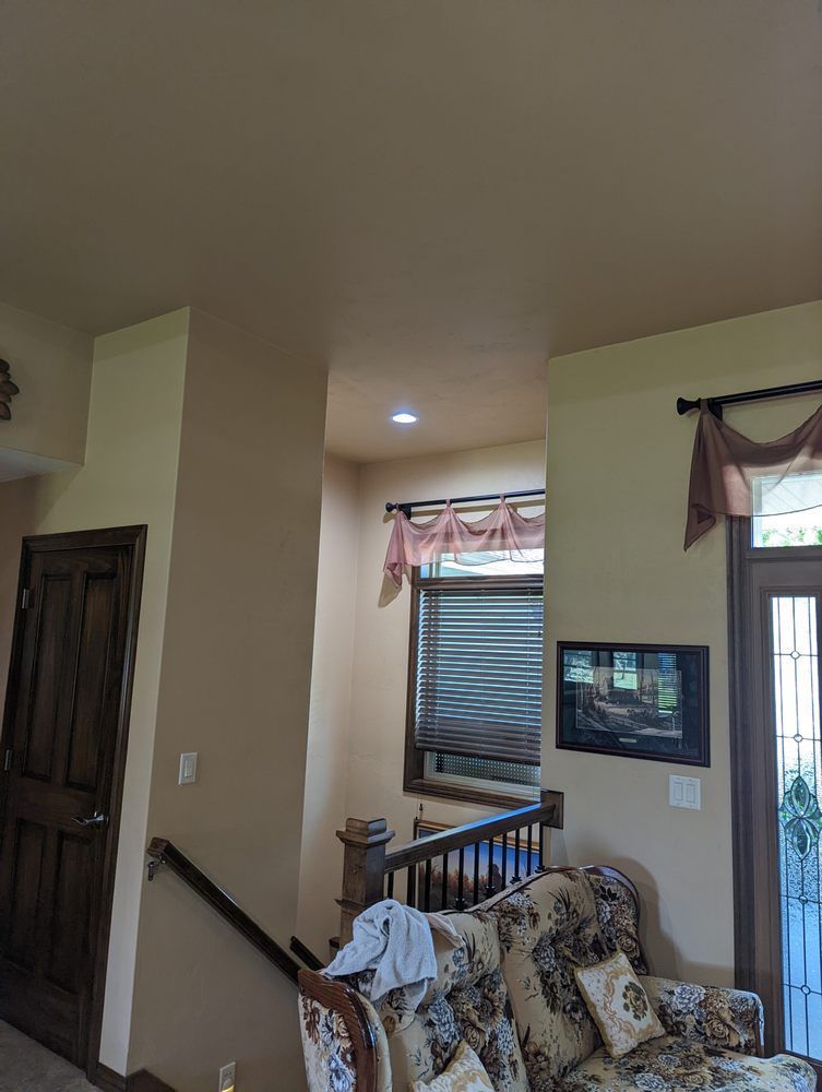 A living room with a couch , chair , and stairs.