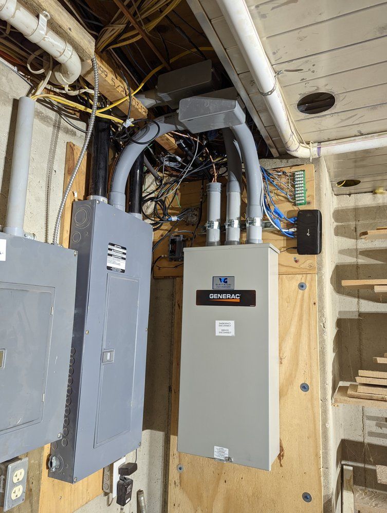A electrical box is hanging from the ceiling of a room.