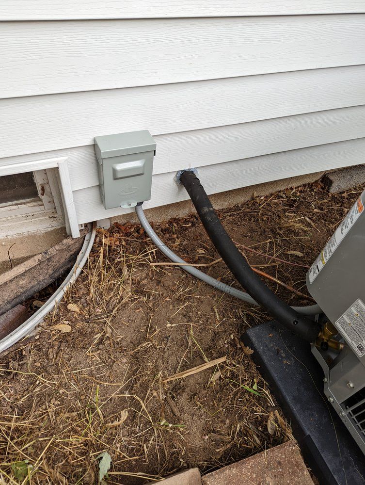 A hose is attached to the side of a house.