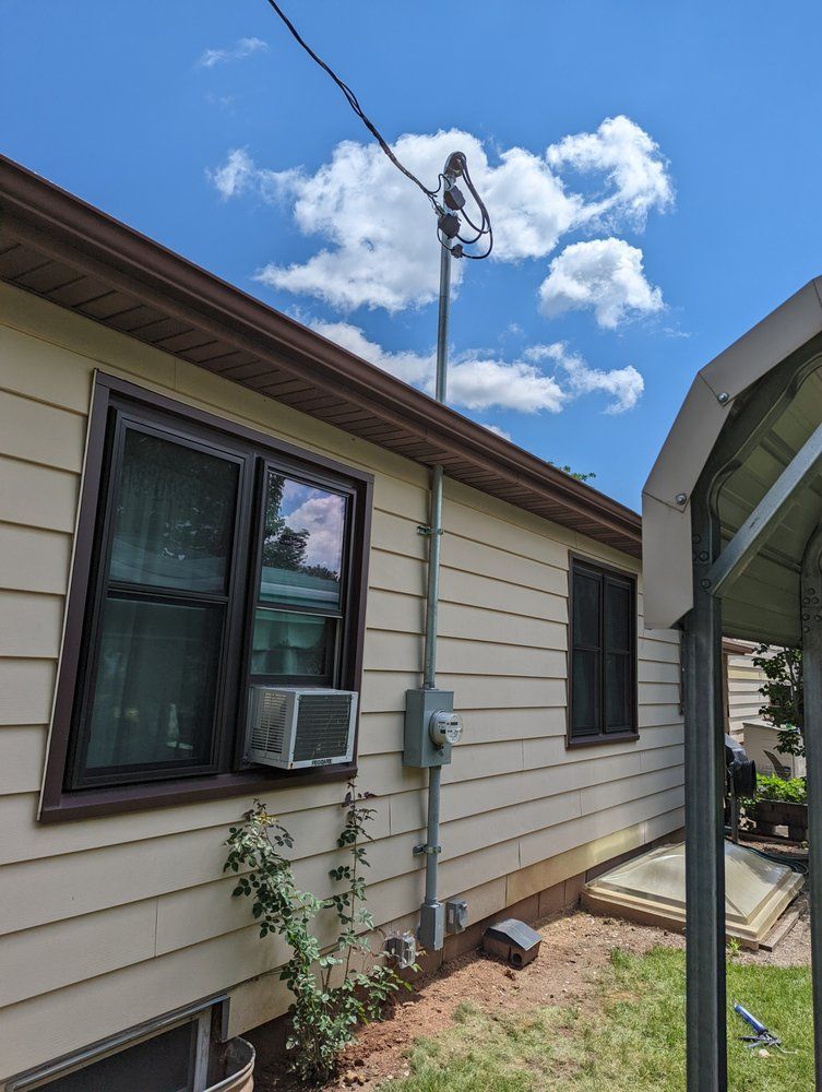 A house with a air conditioner on the side of it.
