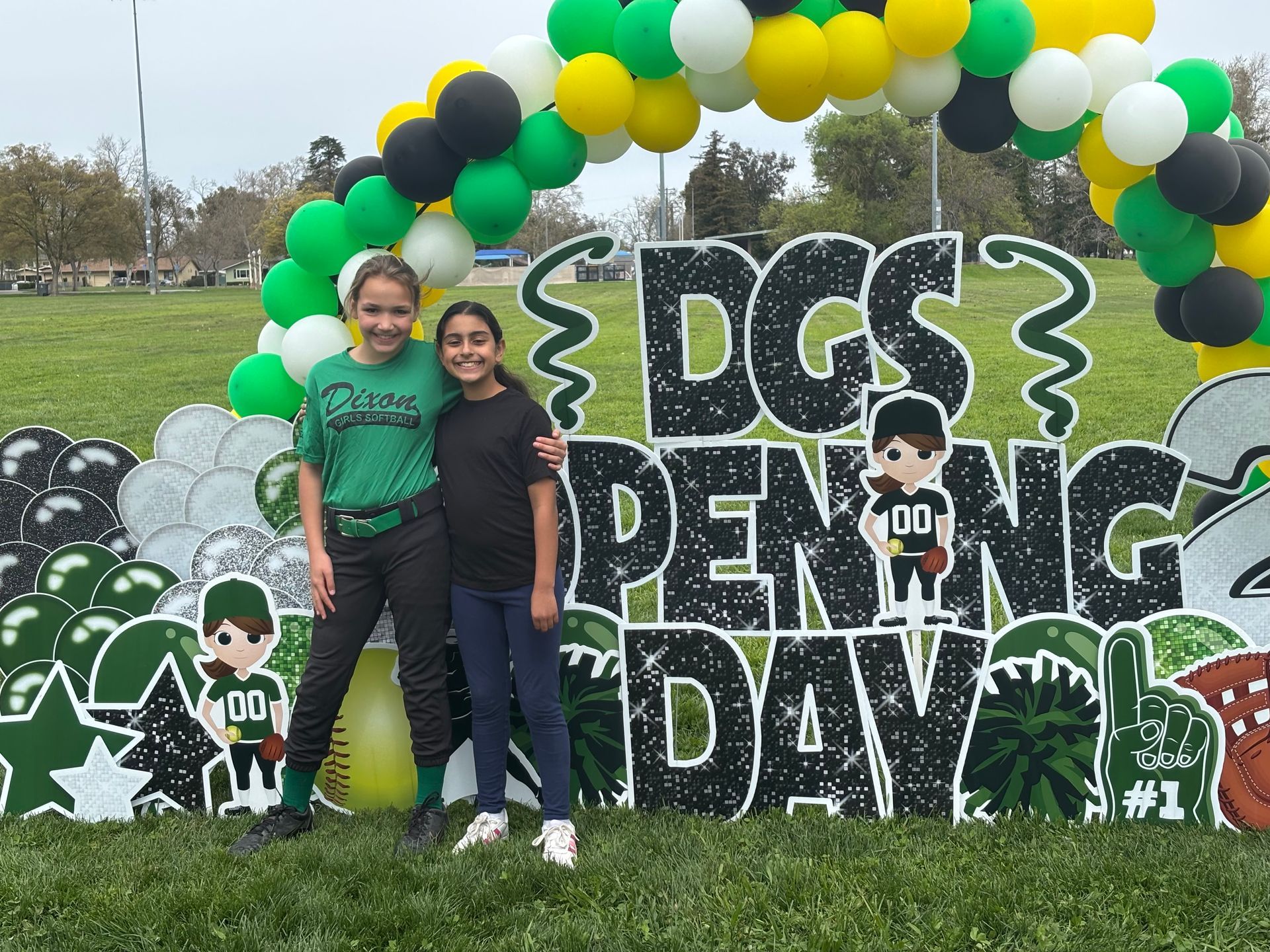 Baseball player sliding into base as another player attempts to catch the ball.