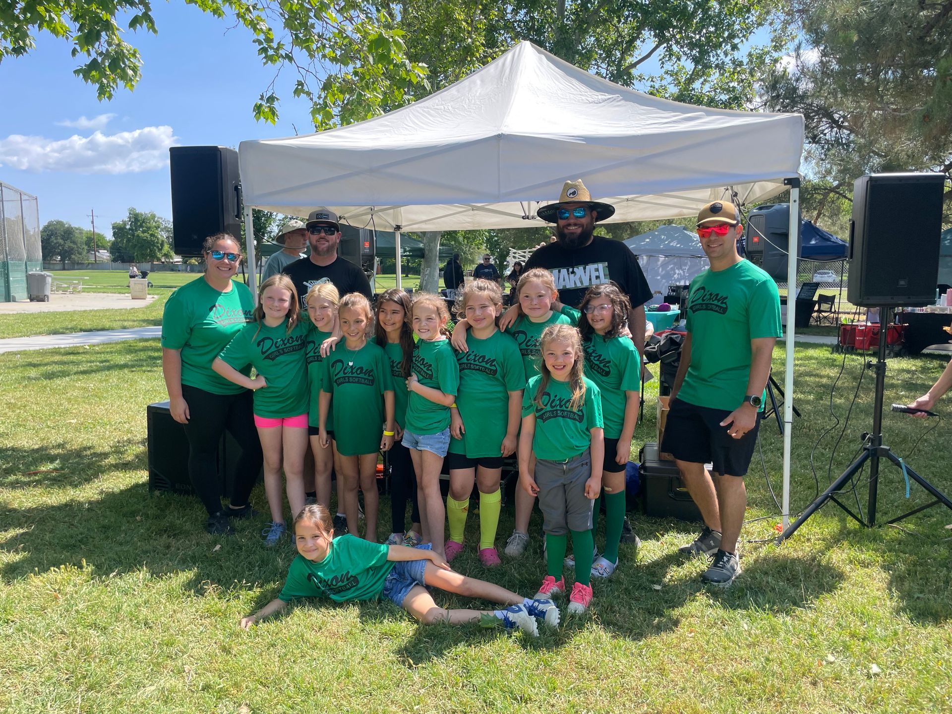 Baseball player sliding into base as another player attempts to catch the ball.