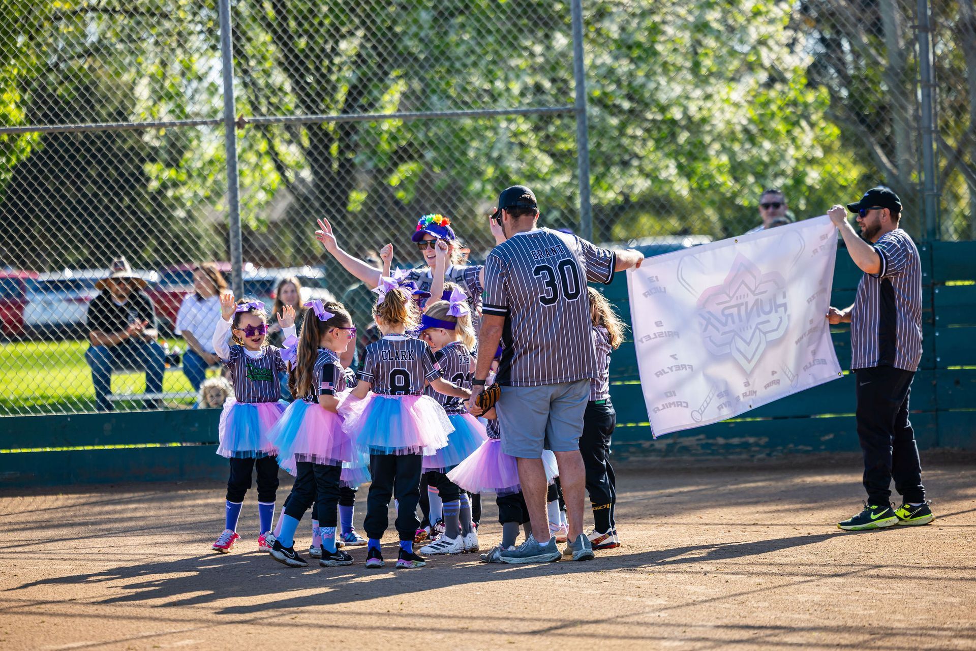 Baseball player sliding into base as another player attempts to catch the ball.