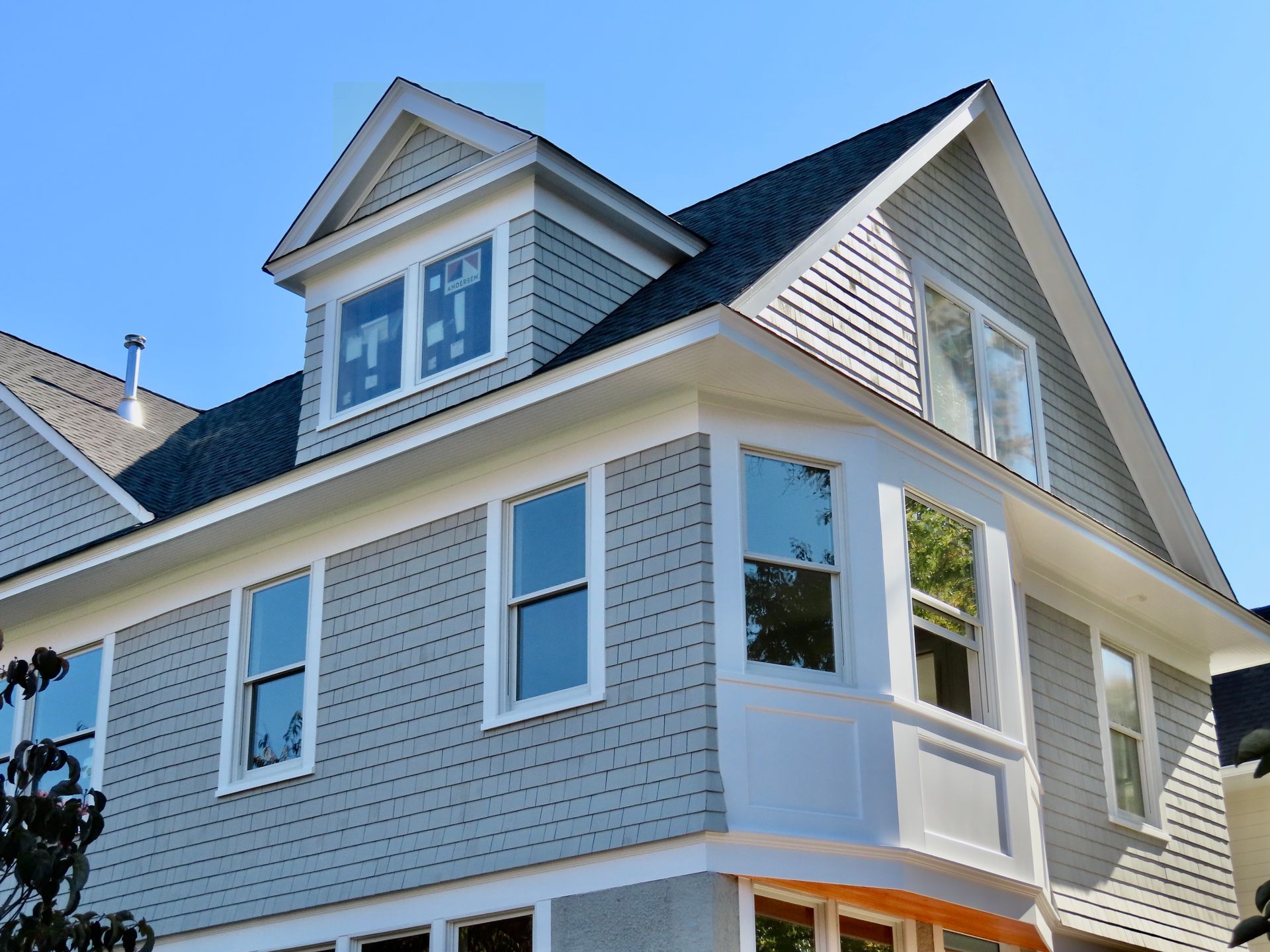 A large house with a blue sky in the background