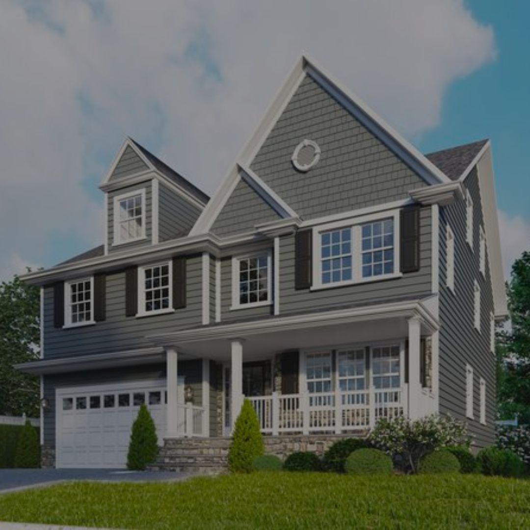 A large gray house with white trim and black shutters