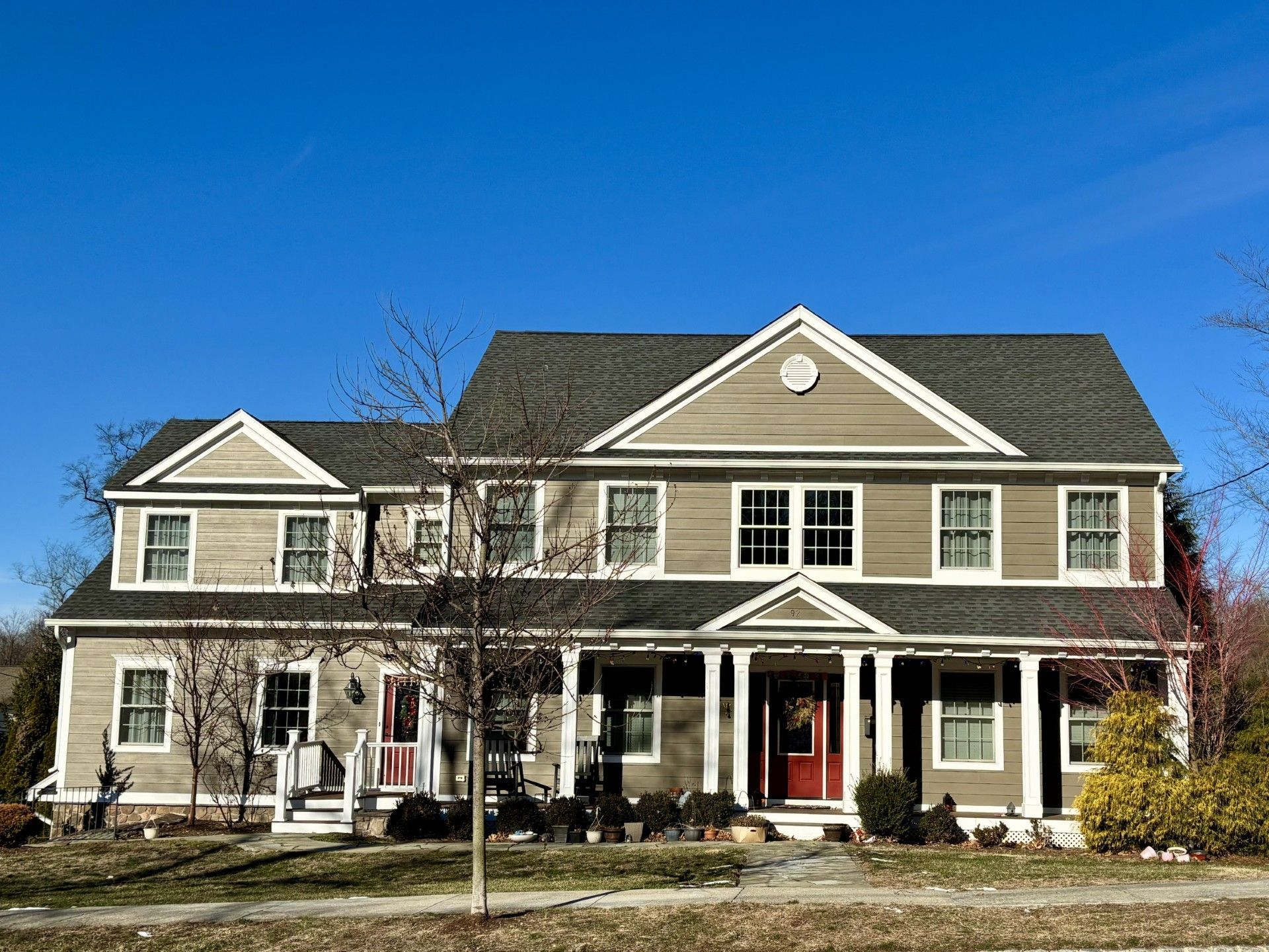 A large house with a blue sky in the background