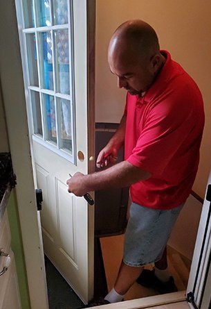 Worker Fixing Door Lock — Omaha, NE — Professional Lock and Safe