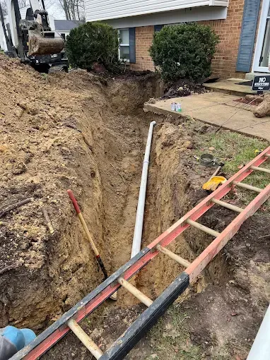 Copper pipes and water filter system against white wall.