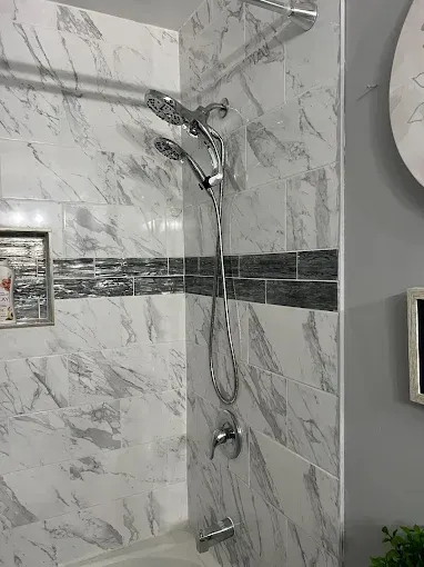 Copper pipes and water filter system against white wall.