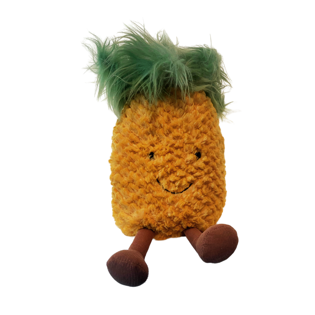 A stuffed pineapple with arms and legs and a smiley face.