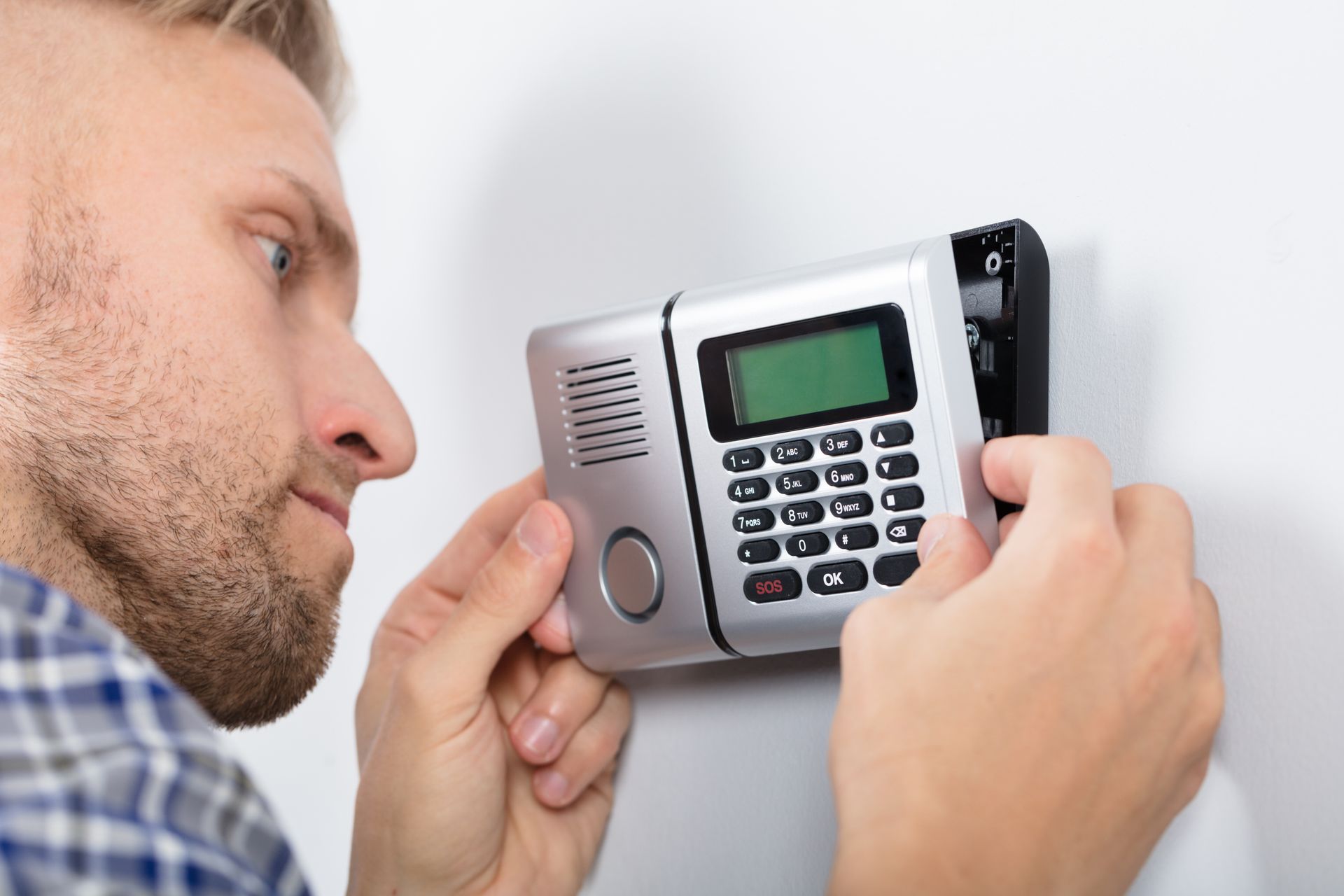 hvac technician repairing thermostat