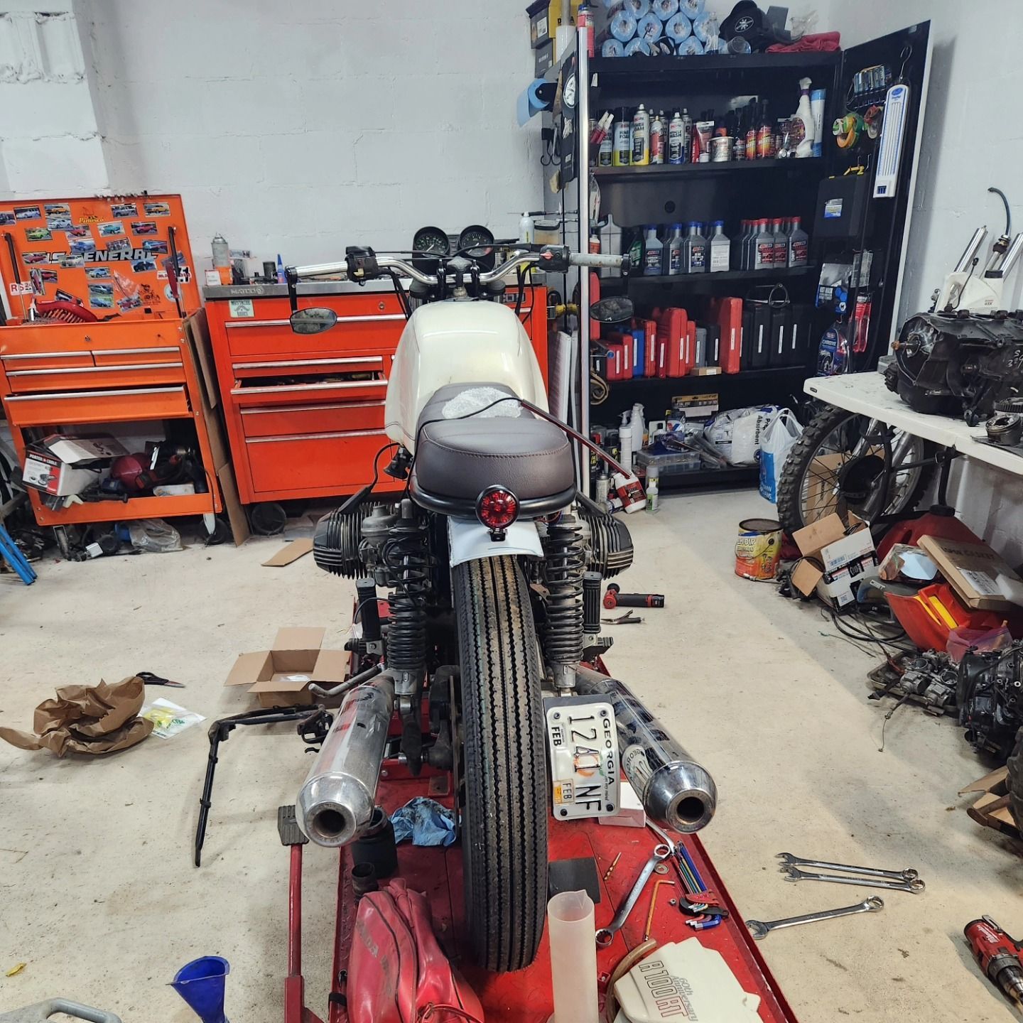 A motorcycle is being worked on in a garage