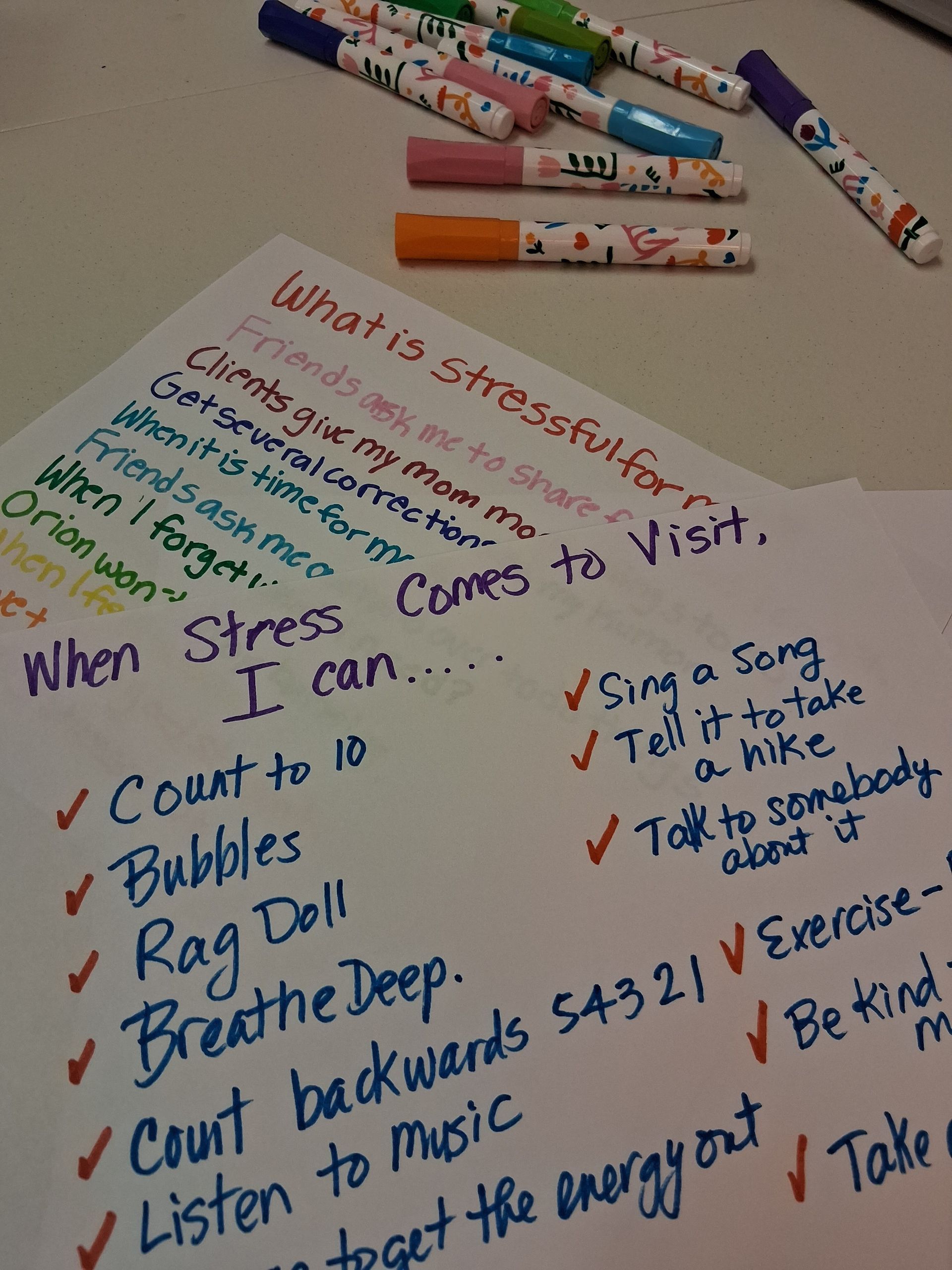A handwritten list with coping strategies for stress written in colorful markers.
