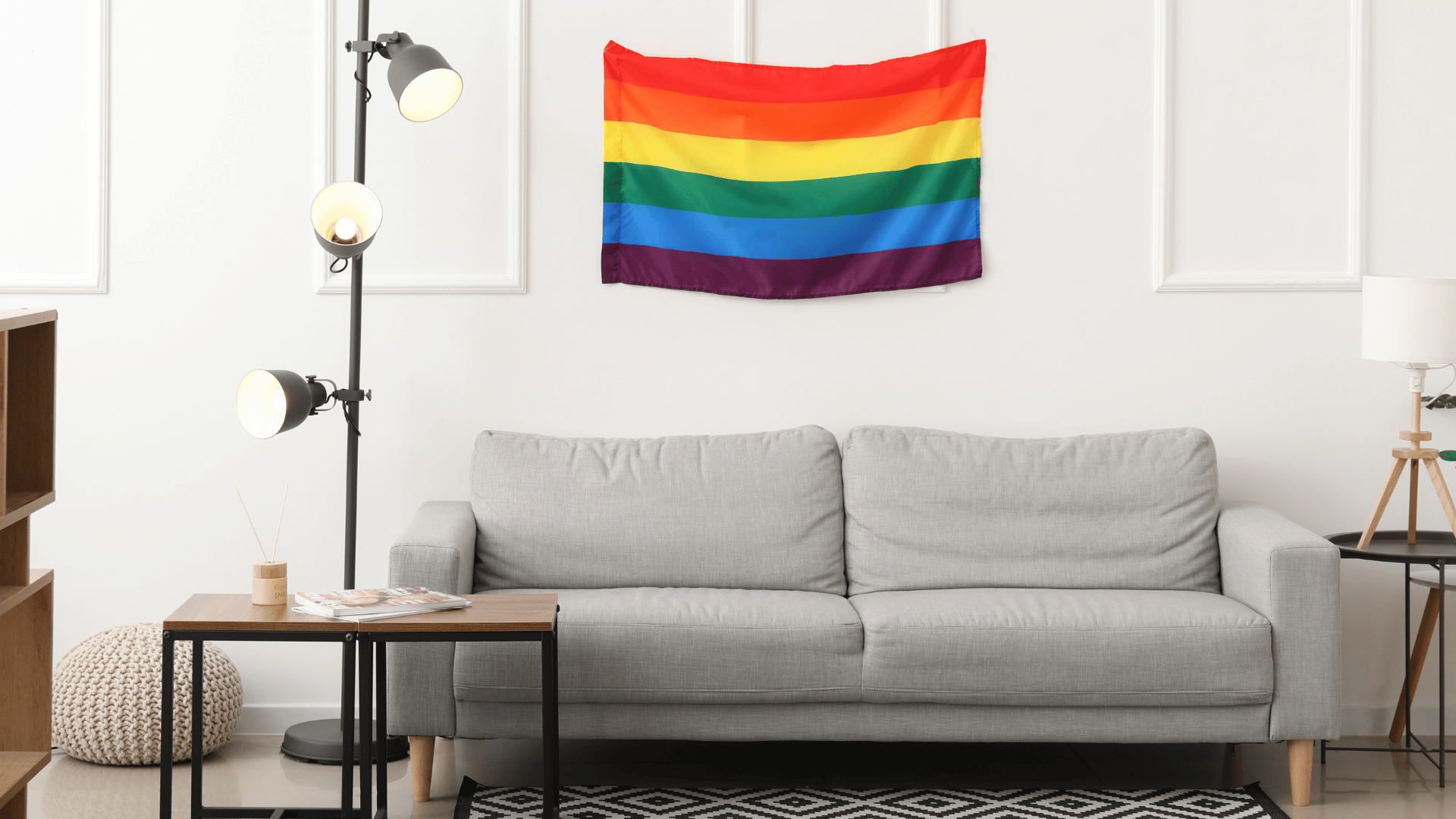 A welcoming therapy room at Mehana Wellness with warm lighting and a pride progress flag displayed