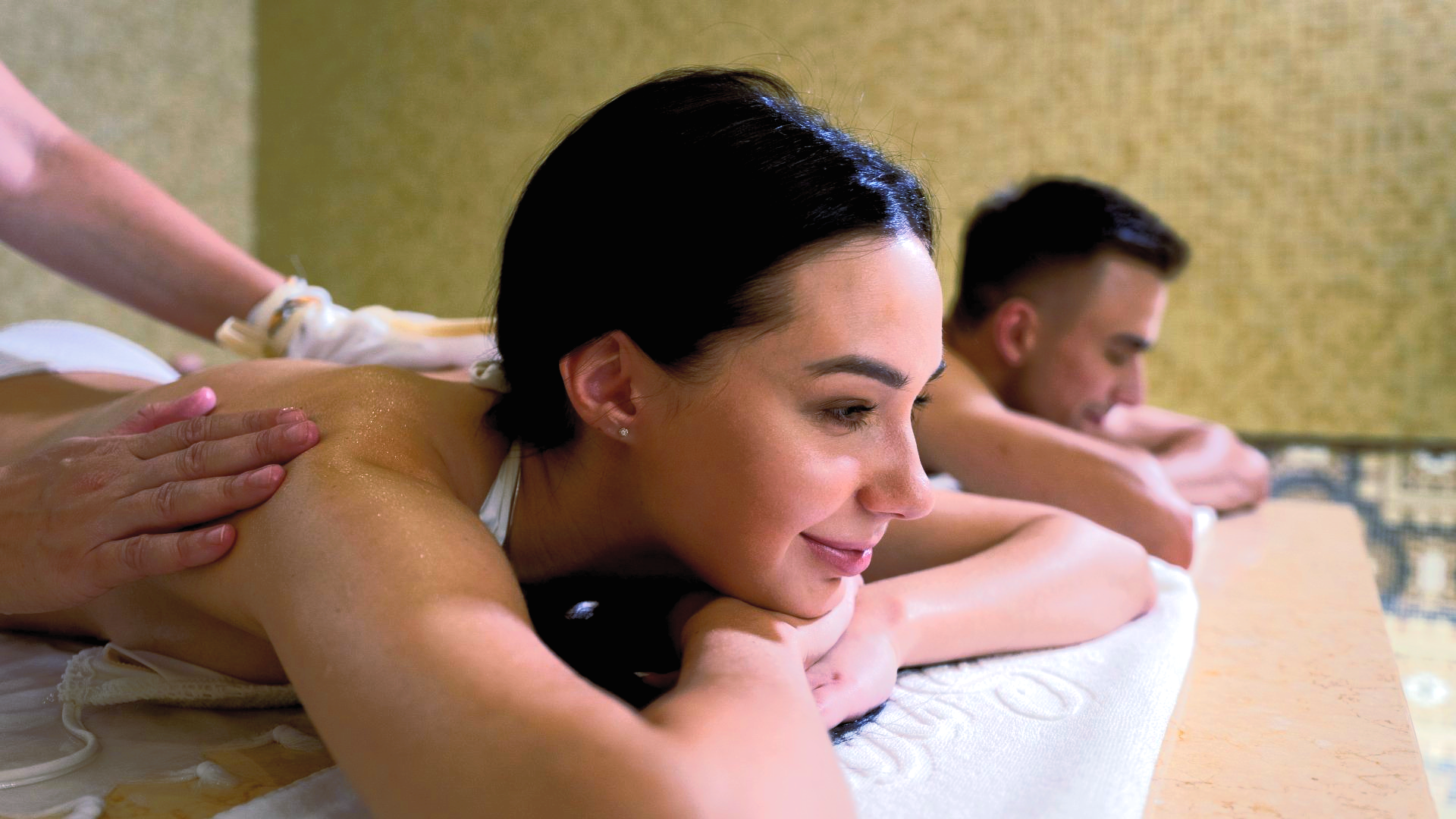 A man and a woman are getting a massage in a spa.