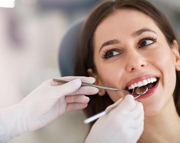 Woman having teeth examined at dentists — Statesville, NC — James J Flerra, DDS PA