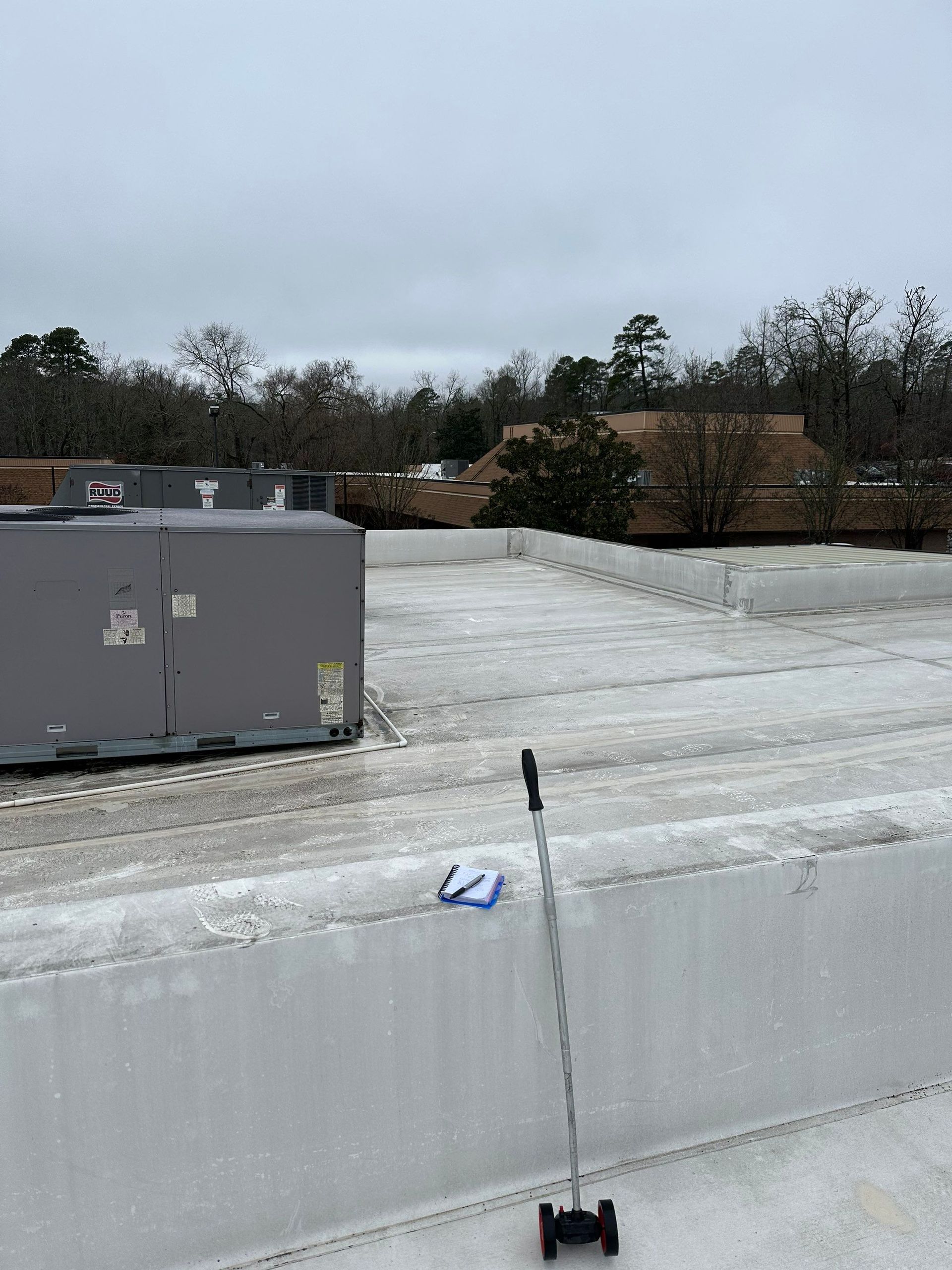 A mop is sitting on the roof of a building.