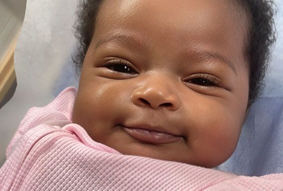 Close-up of a happy, smiling montessori infant.