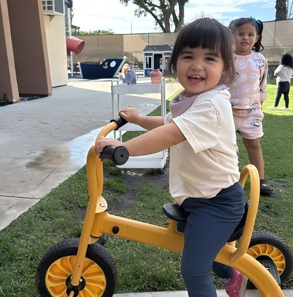 Montessori Preschool Girl Riding Tricycle Outdoor Play