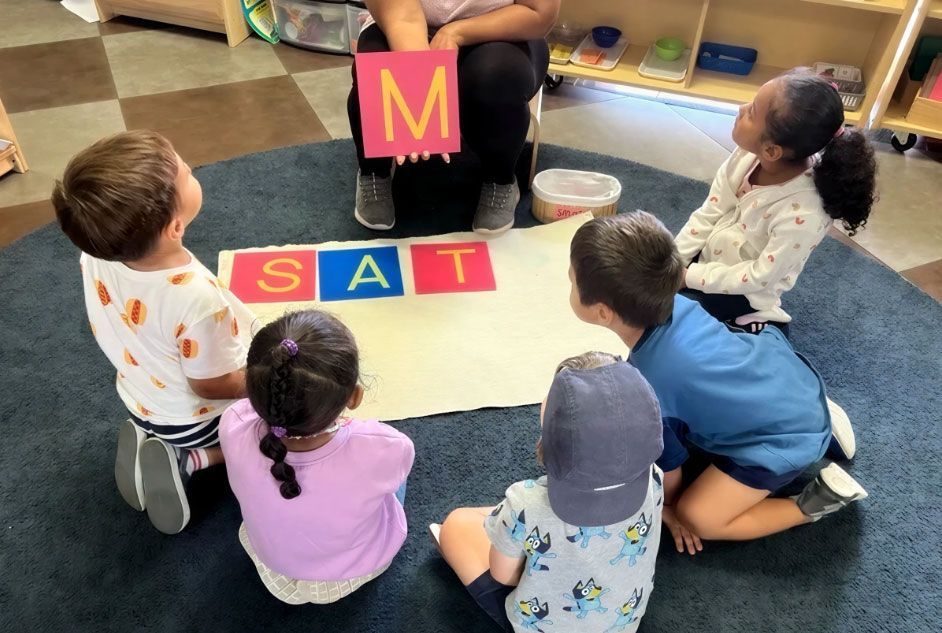 Montessori teacher giving a language lesson with the Movable Alphabet.