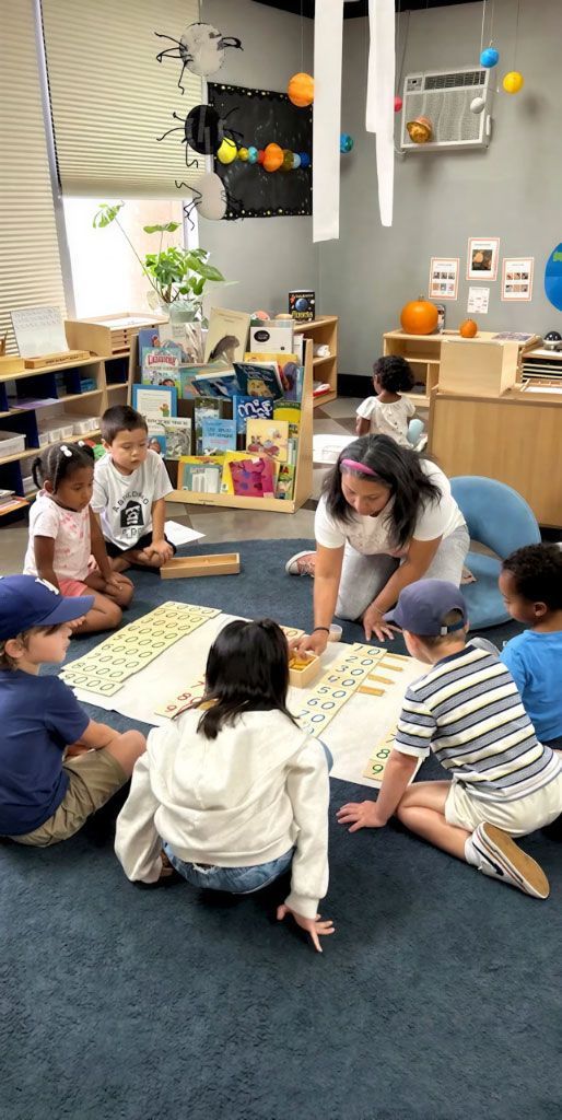 Diverse children receiving a group math lesson from a Montessori teacher in a classroom.